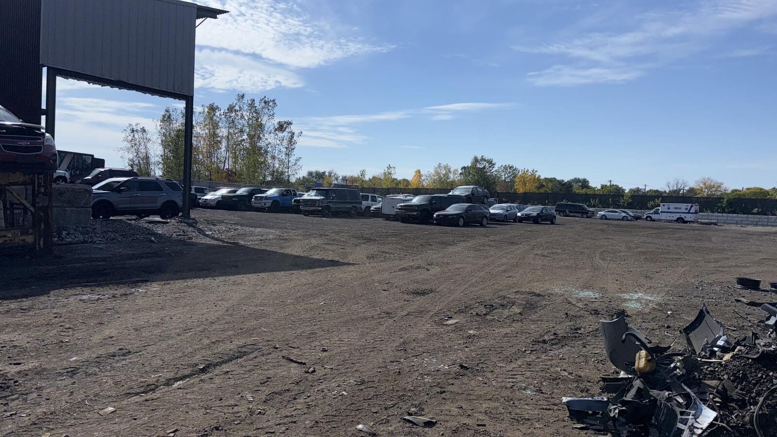 Rows of cars, trucks, and SUVs parked at the Detroit Junk Car Recycling yard