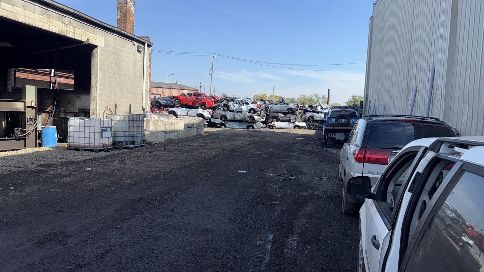 A lane between buildings at the yard where vehicles are unloaded